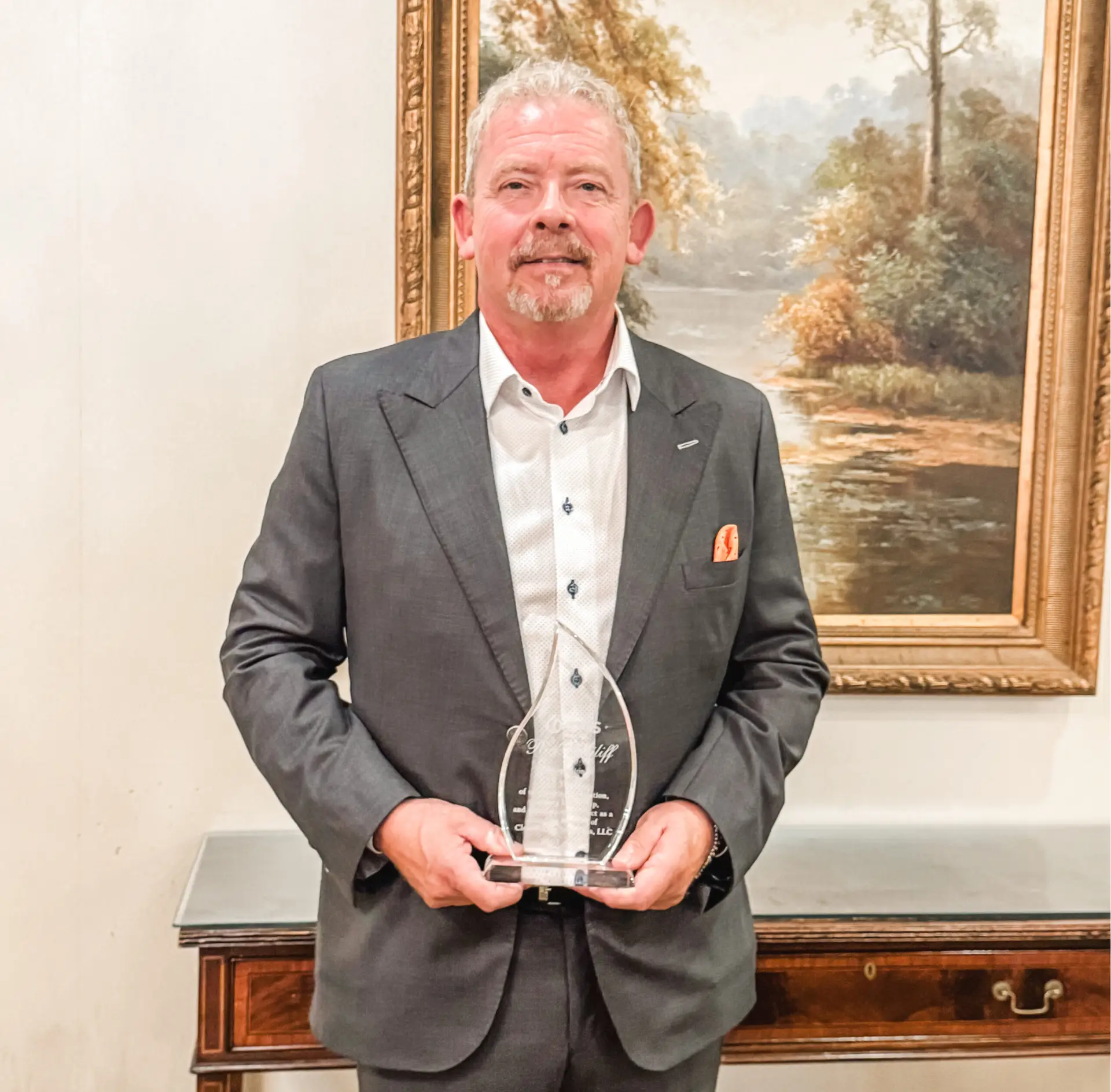 Rick Ailiff holding retirement award