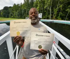 Santonio Rudison holding his certificates
