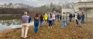 Several people at a water plant listening to someone give them a tour