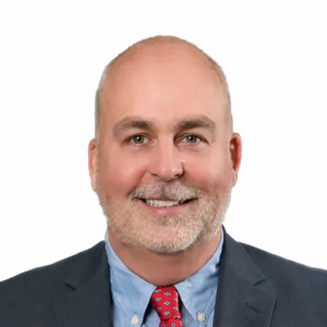 Bryce Mendenhall CEO of Clearwater Solutions in a black suit, red tie, and white background