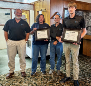 4 members of the CWS Swainsboro team standing together holding award plaques